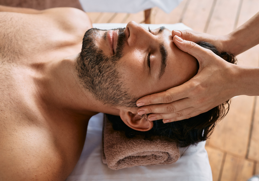 Thai head massage therapy. Adult man enjoying head massage at wellness spa. Antistress procedures
